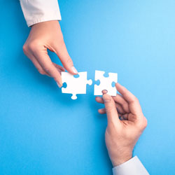 hands holding jigsaw pieces