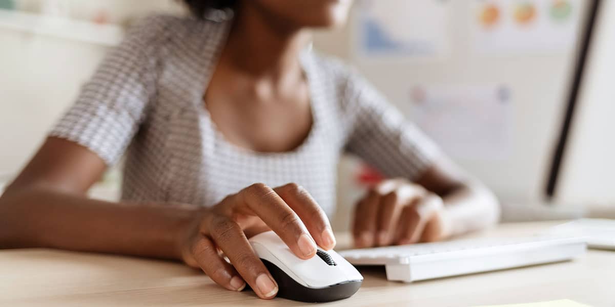Woman clicking on wireless mouse